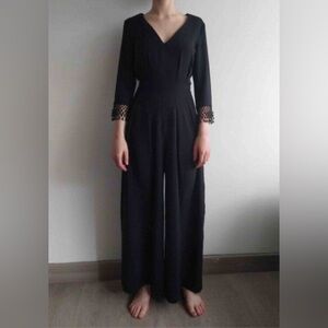 ZARA JUMSUIT SIZE S/XS 

Elegant Black Jumpsuit with Beaded Cuffs